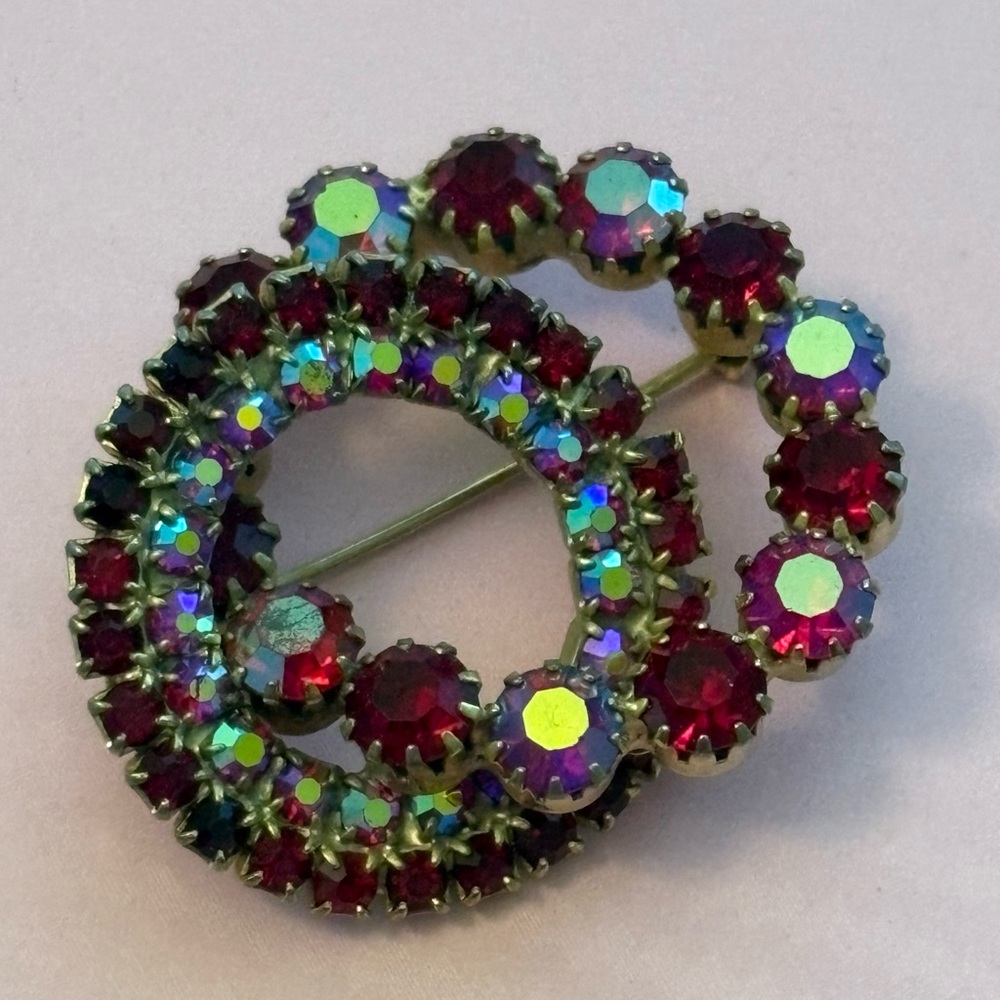 Goldtone red and AB rhinestone double wreath brooch. 1.25 inches by 1.5 inches